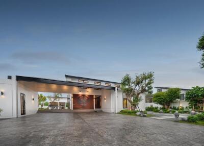 Modern house exterior with spacious driveway and landscaped garden