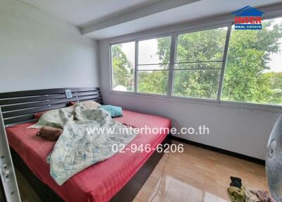 Bedroom with a large bed and window view