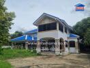 Two-story house with blue roof and white exterior