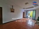 Spacious living room with large windows and tiled floor