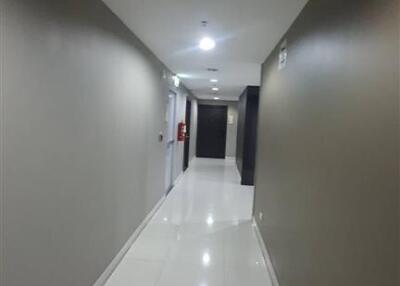 Hallway with white tile flooring and beige walls