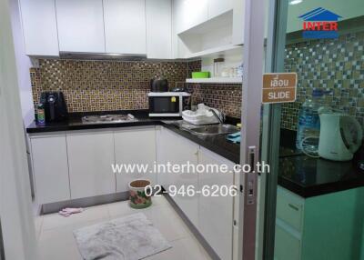 Modern kitchen with appliances and mosaic tile backsplash