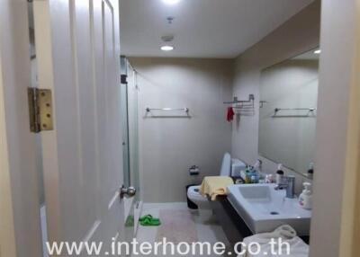 Modern bathroom with sink, toilet, and shower area