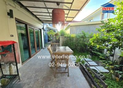 Outdoor patio with a dining table and garden area