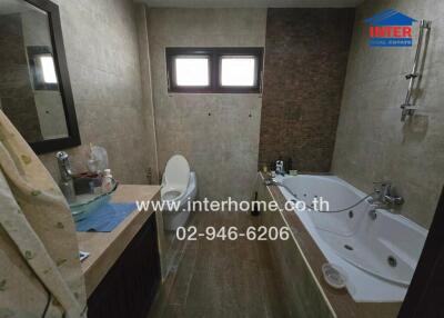 Bathroom with a bathtub, shower, and toilet