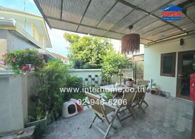 Cozy patio with seating area and hanging plants