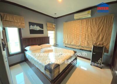 Bedroom with air conditioning, bed, and window treatments