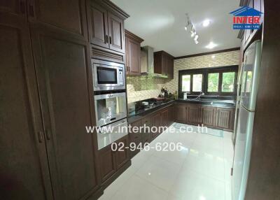 Modern kitchen with wooden cabinets and stainless steel appliances