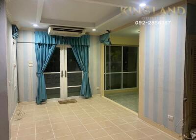 Living room with tiled floor and blue curtains