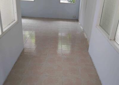 Spacious hallway with tiled floor and ample natural light