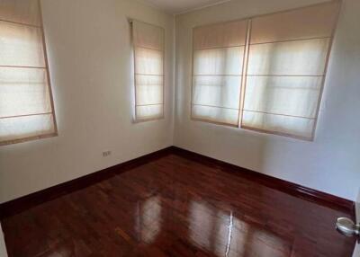 Empty bedroom with wooden floor