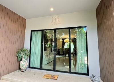 Entrance with sliding glass door and potted plants