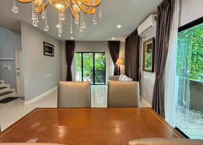 Modern dining room with chandelier and large windows