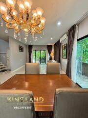 Modern dining room with chandelier and large windows