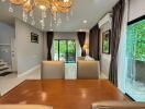 Modern dining room with chandelier and large windows