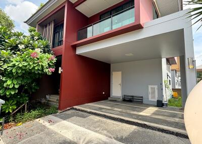 Front view of a modern two-story building with carport