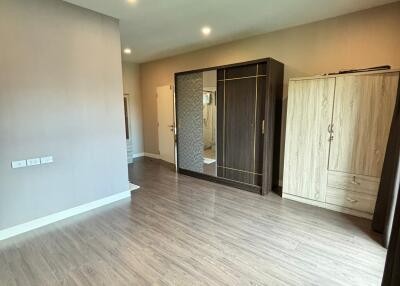 Spacious bedroom with wooden floor and built-in wardrobe