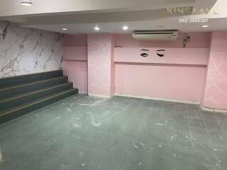 Empty living area with decorative walls and tiled floors