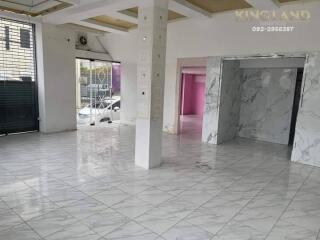 Spacious open area with large windows and tiled flooring