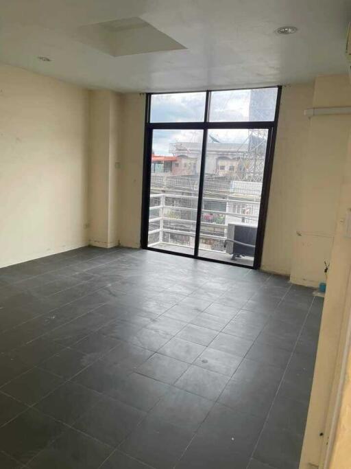 Spacious living room with large window and balcony access