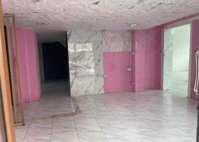 Interior view of a tiled room with marble accents and pink painted walls