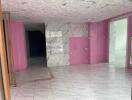 Interior view of a tiled room with marble accents and pink painted walls