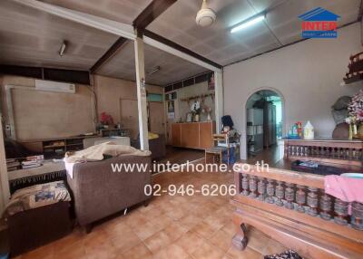 Spacious living area with tiled floor and wooden furniture