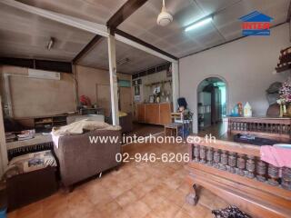 Spacious living area with tiled floor and wooden furniture