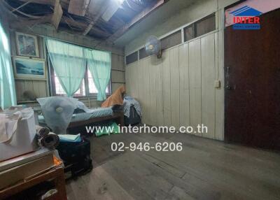 Bedroom with peeling paint and wooden elements