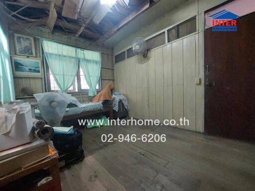 Bedroom with peeling paint and wooden elements