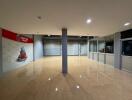 Spacious commercial space with polished floors and large windows