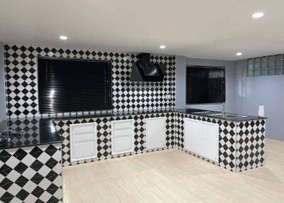 Modern kitchen with black and white checkered tiles