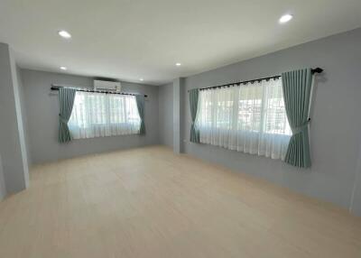 Spacious living room with large windows and curtains