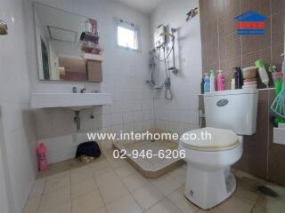 Bathroom with sink, toilet, and shower area