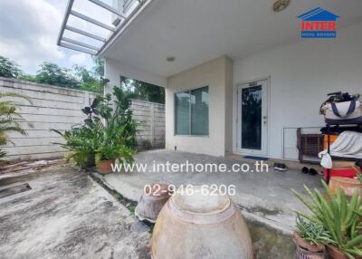 Outdoor area with plants and entrance