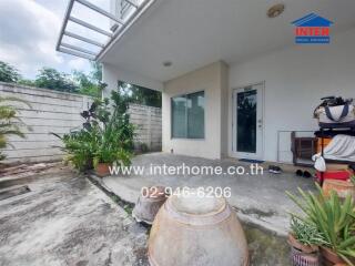 Outdoor area with plants and entrance