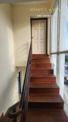 Staircase with wooden steps leading to a door