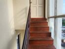 Staircase with wooden steps leading to a door