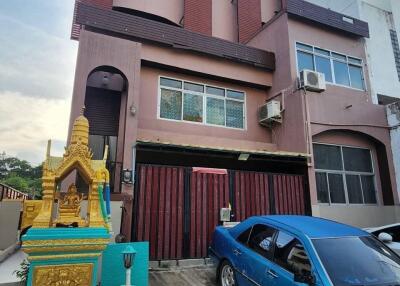 Three-story house with driveway and car