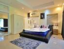 Spacious and modern bedroom with large bed and mirrored wardrobe