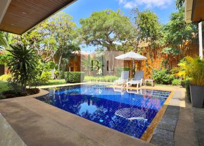 Private swimming pool area in lush garden