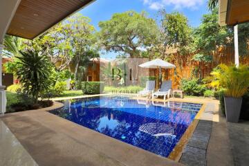 Private swimming pool area in lush garden