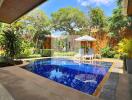 Private swimming pool area in lush garden