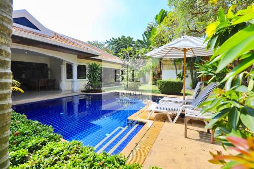 Outdoor area with swimming pool and lounge chairs