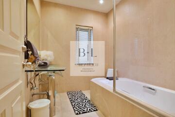 Modern bathroom with glass sink and bathtub