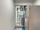 Modern kitchen area with refrigerator and patterned tile floor