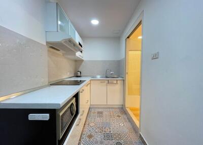 Modern kitchen with appliances and tiled floor