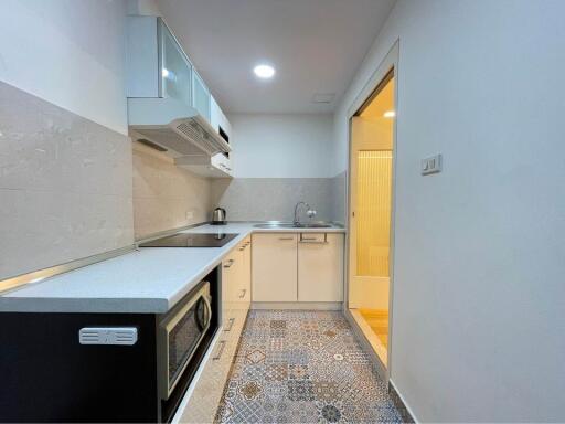 Modern kitchen with appliances and tiled floor