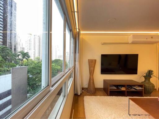 Modern living room with large windows overlooking cityscape