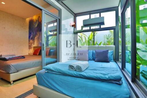 Modern bedroom with large windows and a nature view